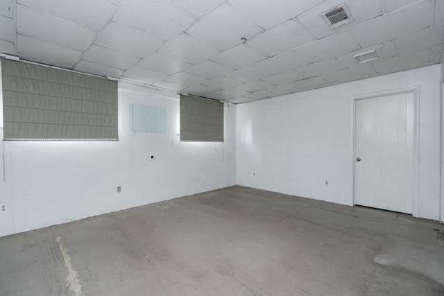 empty room with concrete flooring and visible vents