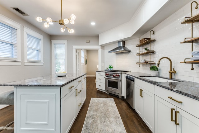 kitchen with wall chimney range hood, open shelves, a sink, stainless steel appliances, and visible vents