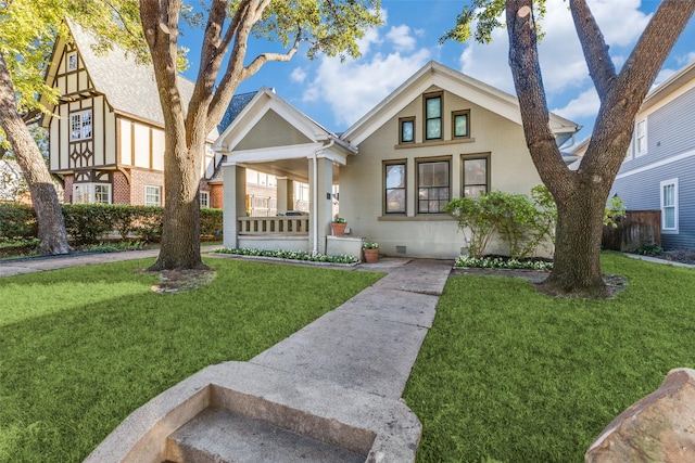 bungalow-style house featuring a porch, brick siding, and a front yard