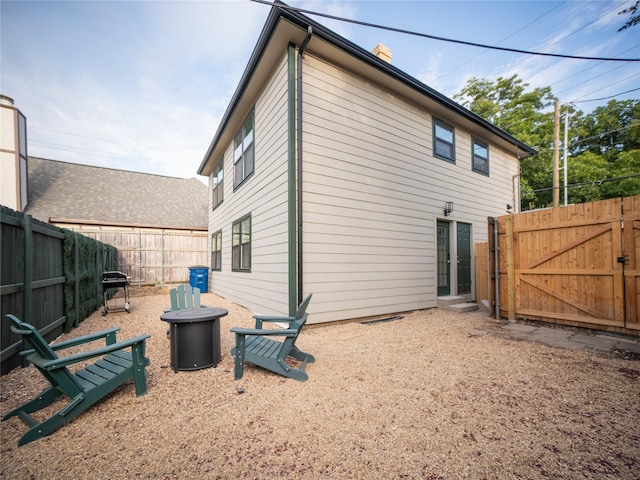 back of house with a gate and a fenced backyard