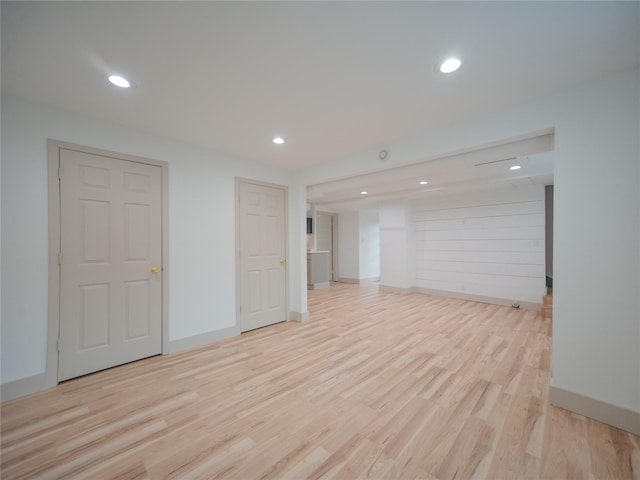 unfurnished room featuring baseboards, recessed lighting, and wood finished floors