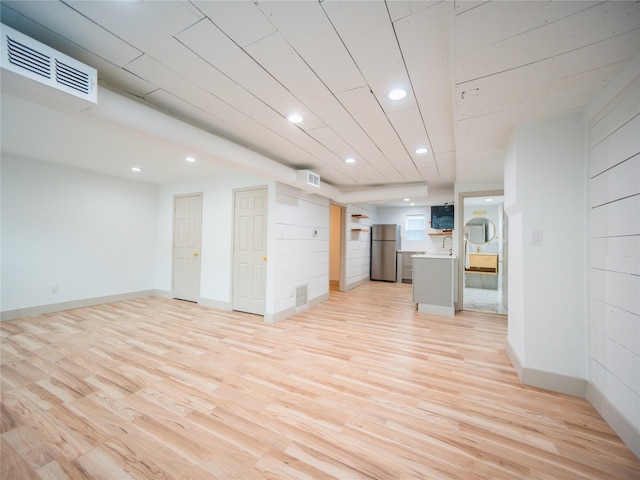 unfurnished living room featuring light wood-style floors, recessed lighting, a sink, and visible vents