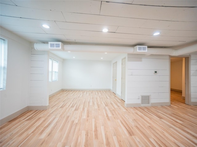 basement featuring recessed lighting, visible vents, and light wood-type flooring
