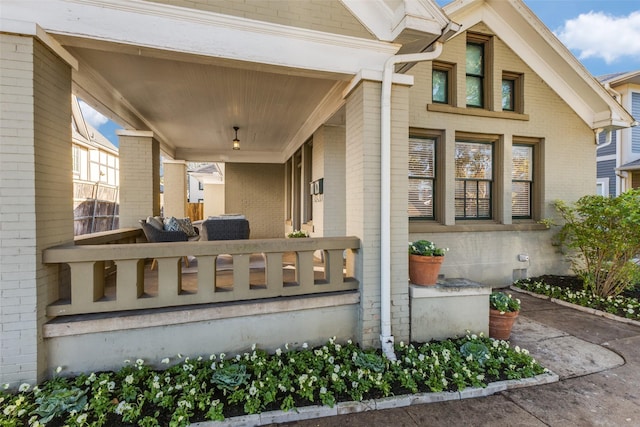 exterior space with brick siding and a porch