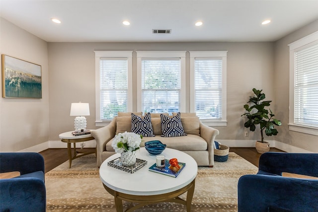 living area featuring baseboards, recessed lighting, wood finished floors, and visible vents