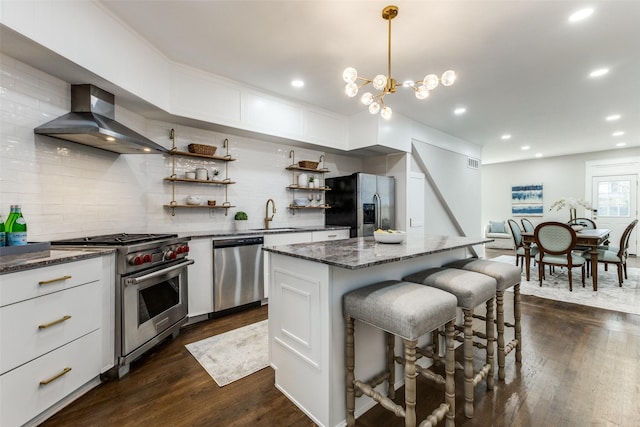kitchen featuring dark wood-style flooring, open shelves, a sink, wall chimney exhaust hood, and stainless steel appliances