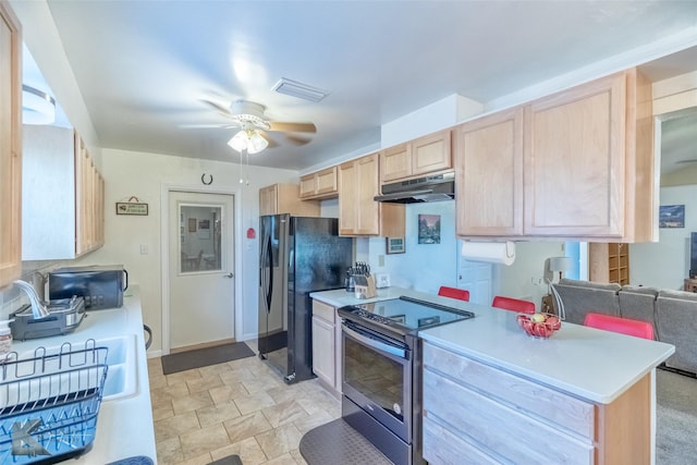 5631 Southmoor Dr, Abilene, TX 79606 - kitchen with light brown cabinetry, a ceiling fan, under cabinet range hood, visible vents, and black appliances