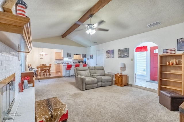 5631 Southmoor Dr, Abilene, TX 79606 - living area featuring visible vents, vaulted ceiling with beams, ceiling fan, and light carpet