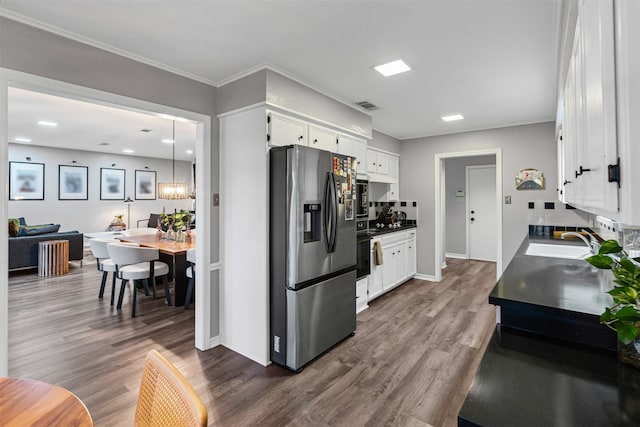832 Havenwood Ln S, Fort Worth, TX 76112 - kitchen with visible vents, stainless steel fridge, dark wood-type flooring, white cabinetry, and a sink
