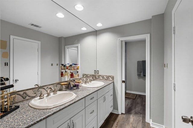 832 Havenwood Ln S, Fort Worth, TX 76112 - bathroom featuring double vanity, a sink, wood finished floors, and visible vents
