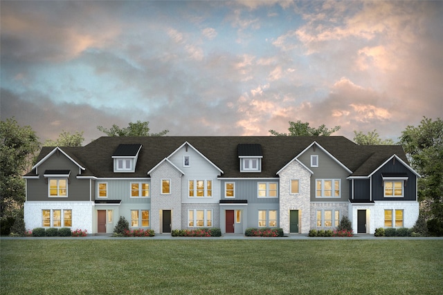 multi unit property with a lawn, board and batten siding, and stone siding