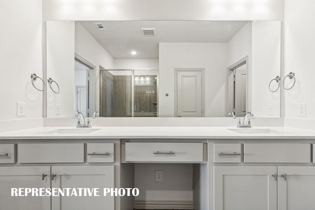 bathroom featuring visible vents, a stall shower, and vanity