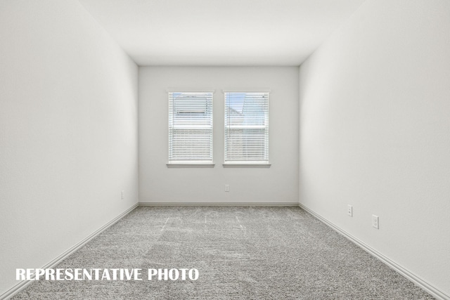 spare room with carpet floors and baseboards