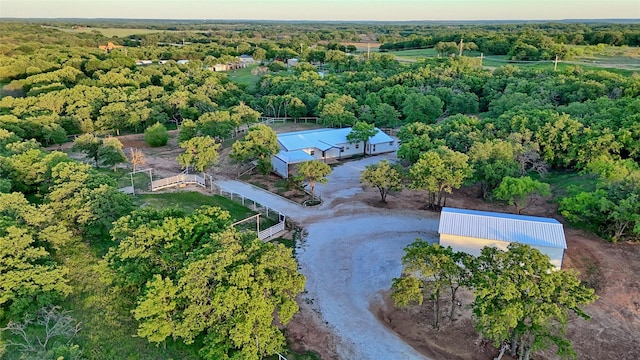 drone / aerial view with a wooded view