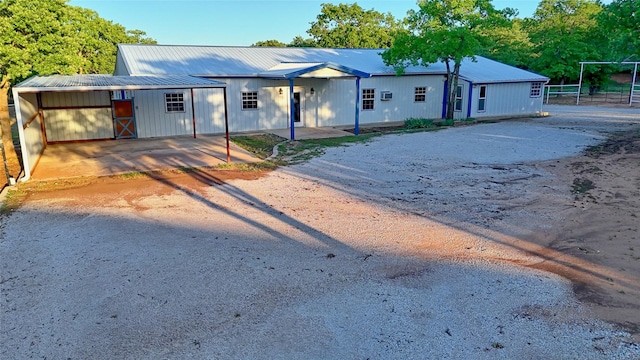 view of front facade with fence and metal roof