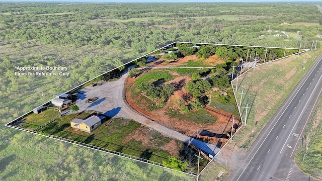 bird's eye view featuring a wooded view