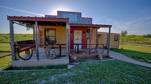 view of front of home featuring fence, a front yard, and metal roof