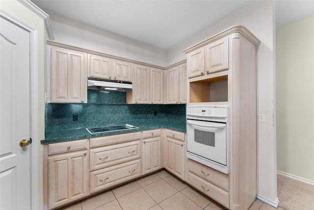 7632 Arbor Ridge Ct, Fort Worth, TX 76112 - kitchen with oven, under cabinet range hood, black electric cooktop, dark countertops, and backsplash