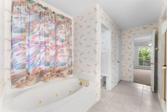 7632 Arbor Ridge Ct, Fort Worth, TX 76112 - bathroom with a jetted tub, a textured ceiling, tile patterned floors, and wallpapered walls