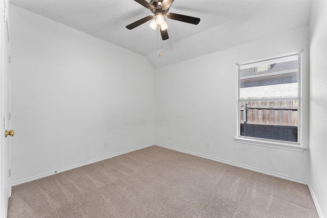 7632 Arbor Ridge Ct, Fort Worth, TX 76112 - empty room featuring carpet flooring, ceiling fan, baseboards, vaulted ceiling, and a textured ceiling