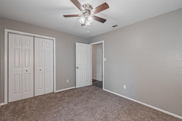 unfurnished bedroom featuring visible vents, a closet, baseboards, ceiling fan, and carpet flooring