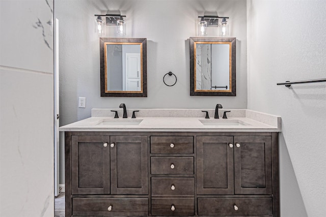 bathroom with a sink and double vanity