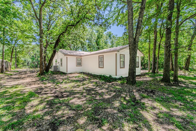 view of side of home featuring central AC unit