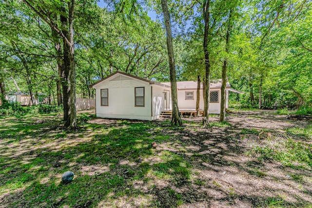 back of property featuring fence
