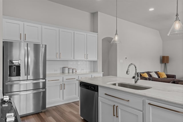 kitchen featuring a sink, white cabinetry, appliances with stainless steel finishes, and tasteful backsplash