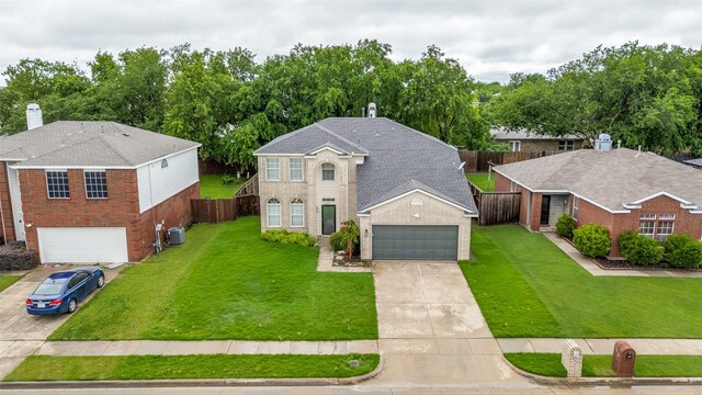 2416 Dogwood Dr, Little Elm, TX 75068 - view of front of house with central AC, concrete driveway, a garage, and brick siding