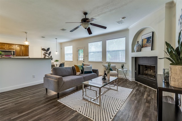 2416 Dogwood Dr, Little Elm, TX 75068 - living area featuring a ceiling fan, crown molding, a fireplace, dark wood finished floors, and baseboards