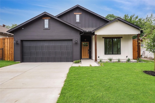 view of front of house with board and batten siding, driveway, fence, a garage, and a front yard