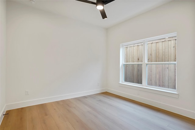 unfurnished room featuring baseboards, a ceiling fan, and wood finished floors