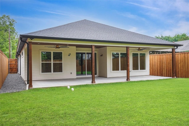 rear view of house with a patio area, a ceiling fan, and a lawn