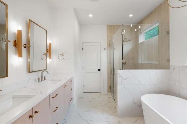 full bath featuring a sink, double vanity, a stall shower, and a freestanding tub