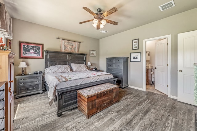 bedroom with ceiling fan, baseboards, visible vents, and wood finished floors