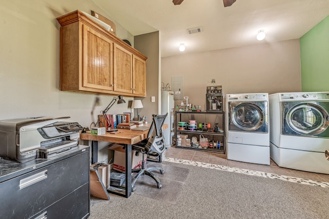 clothes washing area featuring visible vents, ceiling fan, washing machine and clothes dryer, cabinet space, and water heater
