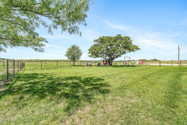 view of yard with a rural view and fence