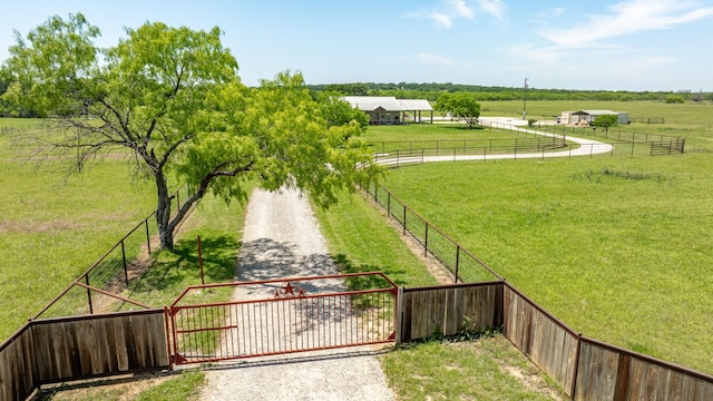 exterior space featuring fence, a gate, and a rural view
