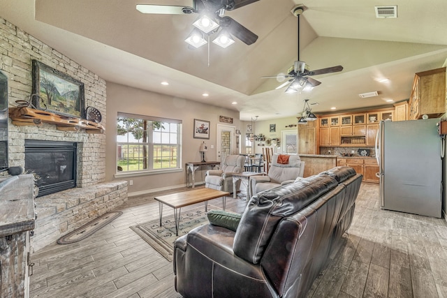 living area with visible vents, ceiling fan, and light wood-type flooring