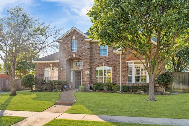 907 Ozark Dr, Allen, TX 75002 - traditional-style house with brick siding, a front lawn, and fence
