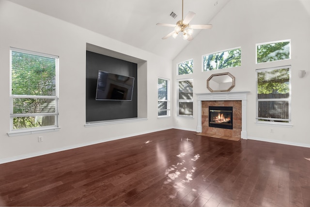 907 Ozark Dr, Allen, TX 75002 - unfurnished living room featuring a ceiling fan, wood finished floors, a healthy amount of sunlight, and a tile fireplace