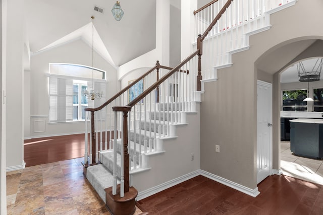 907 Ozark Dr, Allen, TX 75002 - stairs featuring a healthy amount of sunlight, high vaulted ceiling, a chandelier, and visible vents