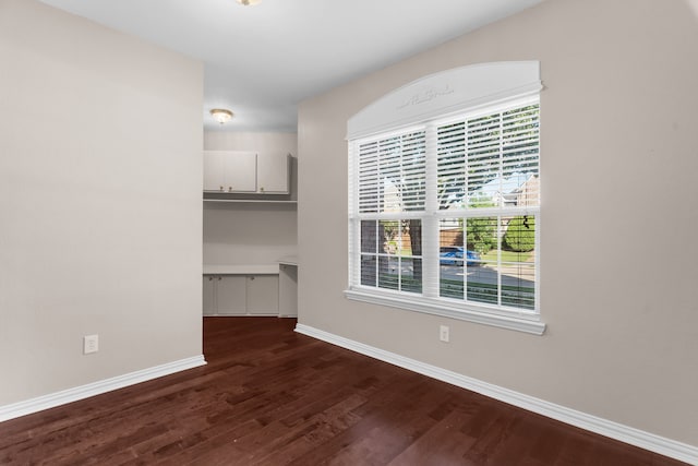 907 Ozark Dr, Allen, TX 75002 - unfurnished dining area featuring baseboards and dark wood-type flooring