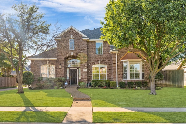 907 Ozark Dr, Allen, TX 75002 - view of front facade featuring brick siding, a front lawn, and fence