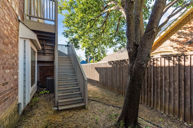 907 Ozark Dr, Allen, TX 75002 - view of yard with a fenced backyard, stairs, and central air condition unit