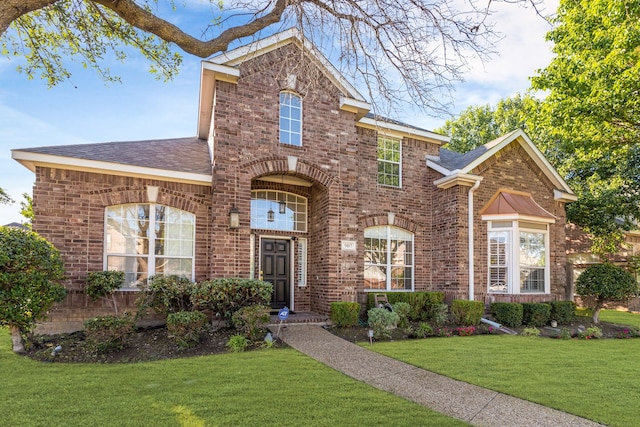 907 Ozark Dr, Allen, TX 75002 - view of front of home featuring brick siding, a shingled roof, and a front yard