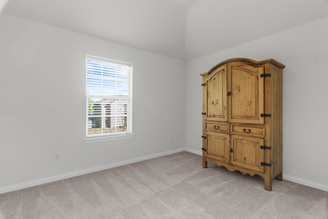907 Ozark Dr, Allen, TX 75002 - spare room featuring baseboards, light carpet, and lofted ceiling