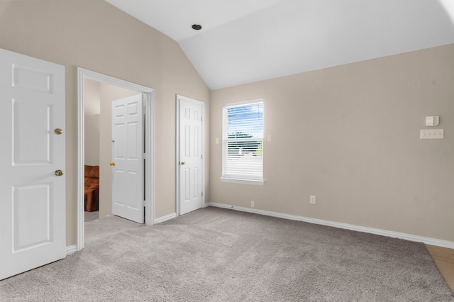 907 Ozark Dr, Allen, TX 75002 - unfurnished bedroom featuring baseboards, carpet, and lofted ceiling