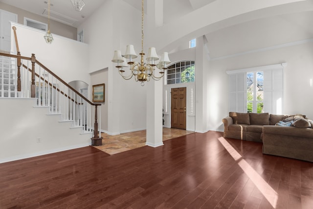 907 Ozark Dr, Allen, TX 75002 - entryway with stairs, wood finished floors, high vaulted ceiling, a chandelier, and arched walkways